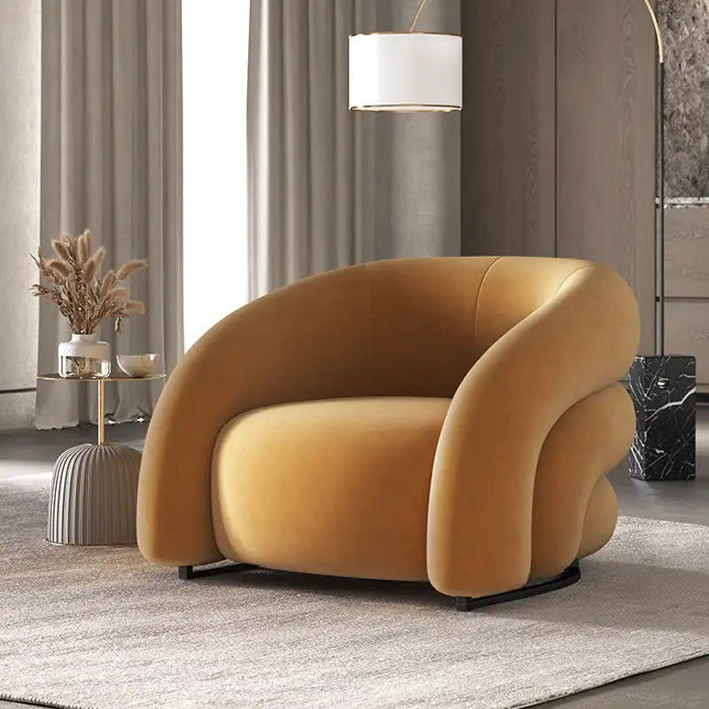 Mustard yellow velvet armchair with curved back and seat design, modern style.